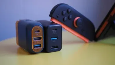 Close-up of USB-C chargers and Nintendo Switch controller on yellow surface.