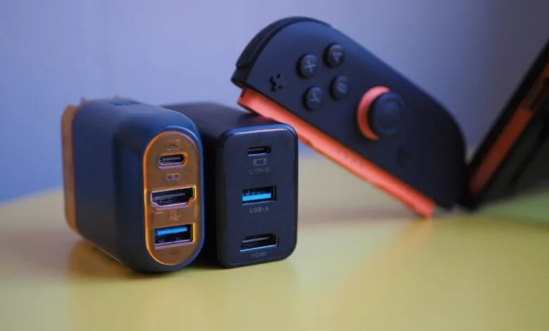 Close-up of USB-C chargers and Nintendo Switch controller on yellow surface.