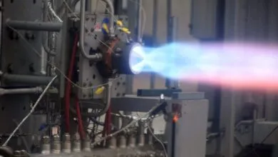 Rocket engine firing with blue and red exhaust plume.
