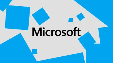 Microsoft logo with blue squares on a light gray background.