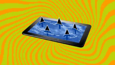 Tablet screen shows shark fins in water, symbolizing online dangers.