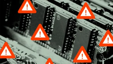 Close-up of computer RAM with warning signs indicating potential issues.