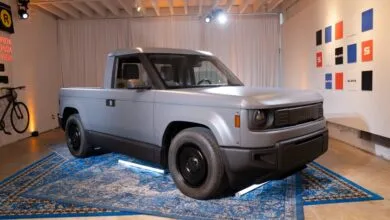 Gray Slate truck on blue rug, minimalist design, well-lit studio.