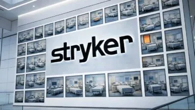 Stryker logo on wall with hospital room images, modern design.