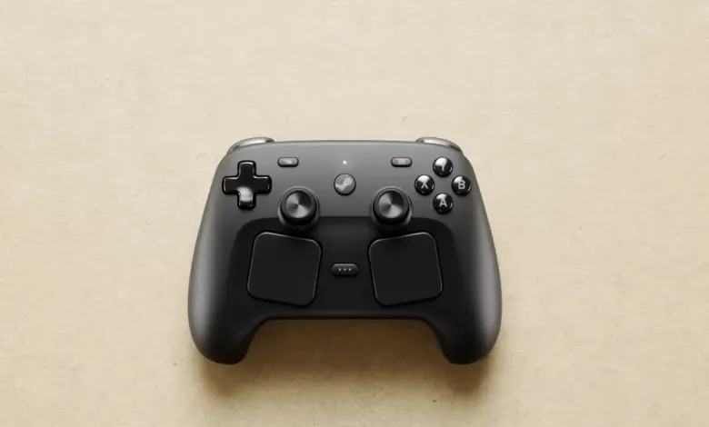 Black Steam Controller on a beige surface, top-down view.