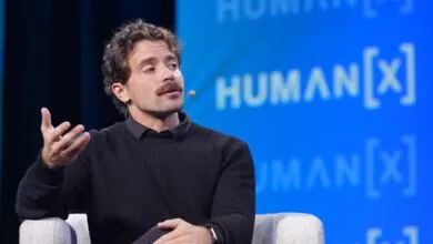 Guillermo Rauch speaks at Human[X] conference, gesturing with his hand.