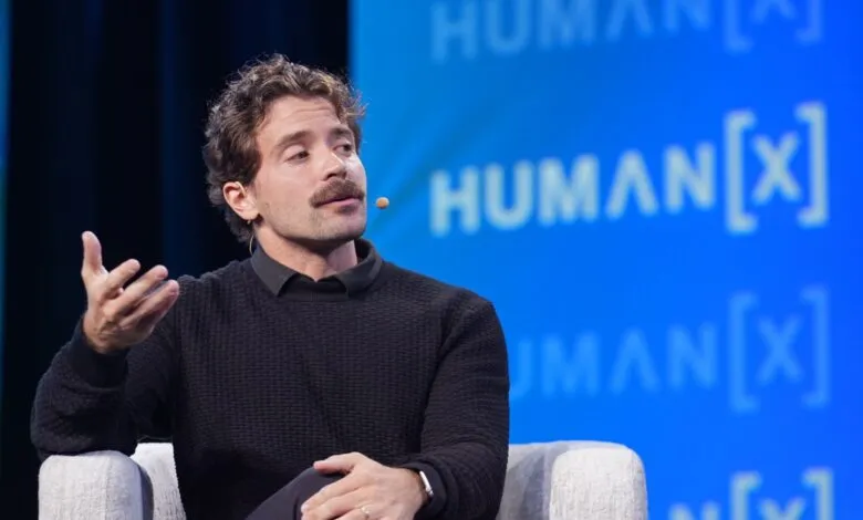 Guillermo Rauch speaks at Human[X] conference, gesturing with his hand.
