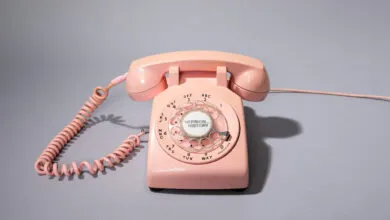 Vintage pink rotary phone with 'Version History' on the dial.
