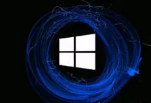 Windows logo surrounded by swirling blue light trails on a black background.