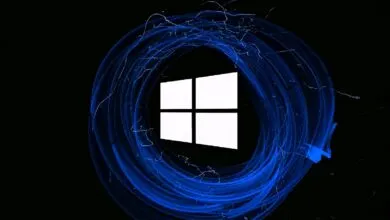 Windows logo surrounded by swirling blue light trails on a black background.