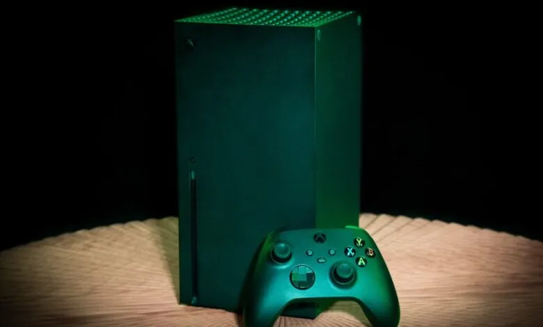 Xbox Series X console and controller on a wooden surface.