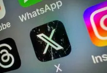 Close-up of a smartphone screen showing the X app icon among other social media apps.