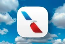 American Airlines app icon against a blue sky with fluffy white clouds.