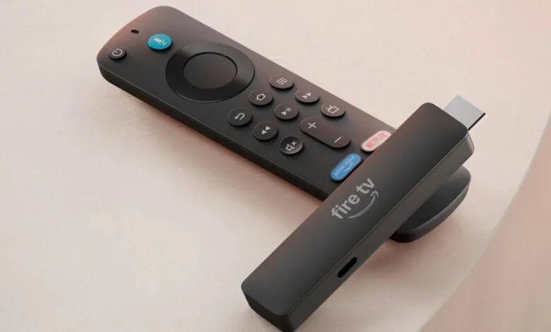 Amazon Fire TV Stick and remote on a light surface.