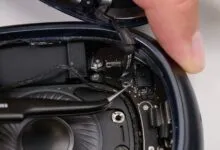 Close-up of AirPods Max internal components during disassembly.