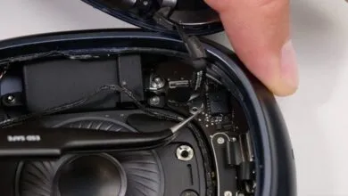 Close-up of AirPods Max internal components during disassembly.