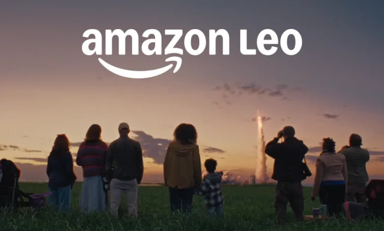 Group watches rocket launch under Amazon Leo logo at sunset.