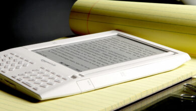 Amazon Kindle e-reader on yellow legal pad, displaying text.