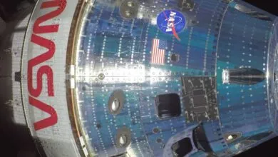 Close-up of spacecraft with NASA logo and American flag.