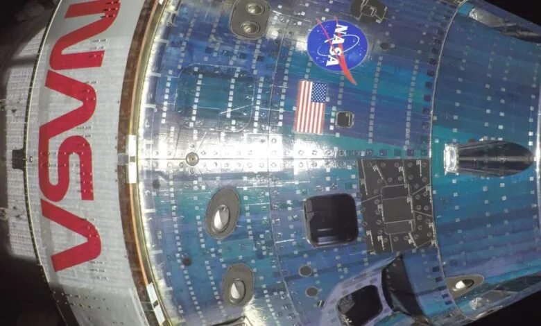 Close-up of spacecraft with NASA logo and American flag.