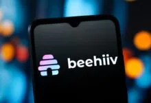 Smartphone displaying the beehiiv logo on a dark screen.