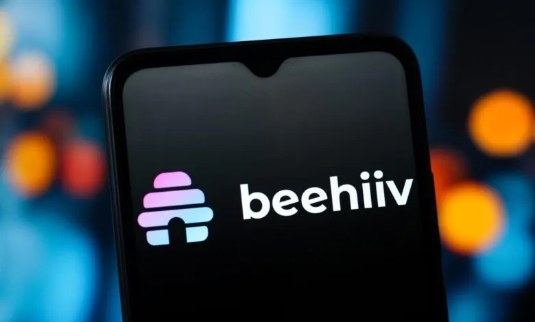 Smartphone displaying the beehiiv logo on a dark screen.