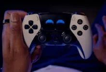 Hands holding a white and black PlayStation controller with glowing blue eyes.