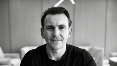 Black and white portrait of a man with a slight smile.