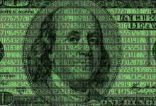 One hundred dollar bill overlaid with green digital code.