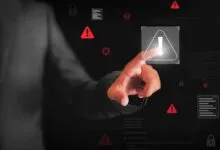 Hand touches digital screen with warning signs, locks, and code snippets.