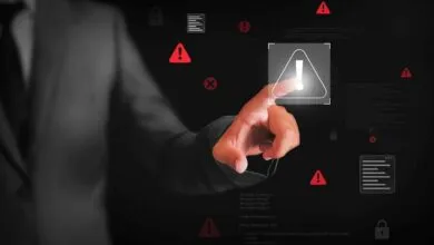 Hand touches digital screen with warning signs, locks, and code snippets.