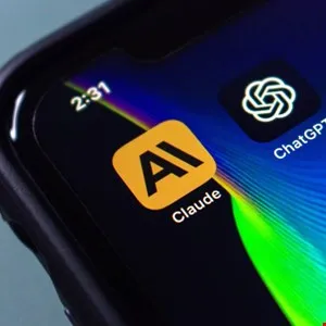 Close-up of a smartphone screen showing the Claude AI app icon and the ChatGPT app icon.