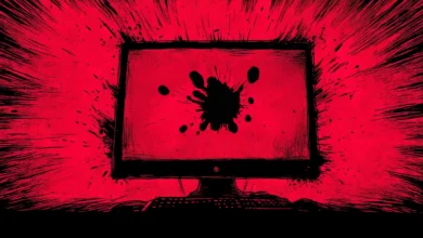 Stylized computer with a black ink splatter on the screen, red background.