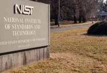 Sign for the National Institute of Standards and Technology (NIST) on a grassy lawn.
