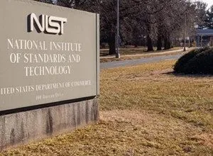 Sign for the National Institute of Standards and Technology (NIST) on a grassy lawn.