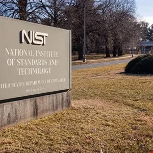 Sign for the National Institute of Standards and Technology (NIST) on a grassy lawn.