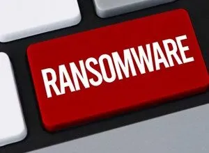 Close-up of a red keyboard key with the word 'RANSOMWARE' in white letters.