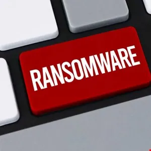 Close-up of a red keyboard key with the word 'RANSOMWARE' in white letters.