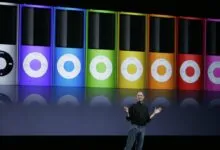 Steve Jobs presents colorful iPod Nanos on stage at Apple event.