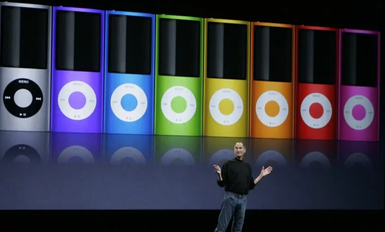 Steve Jobs presents colorful iPod Nanos on stage at Apple event.