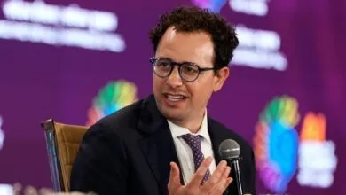 Nathaniel Gleicher speaks at event, wearing glasses and suit.