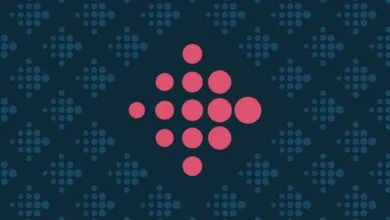 Fitbit logo made of pink circles on a dark blue patterned background.