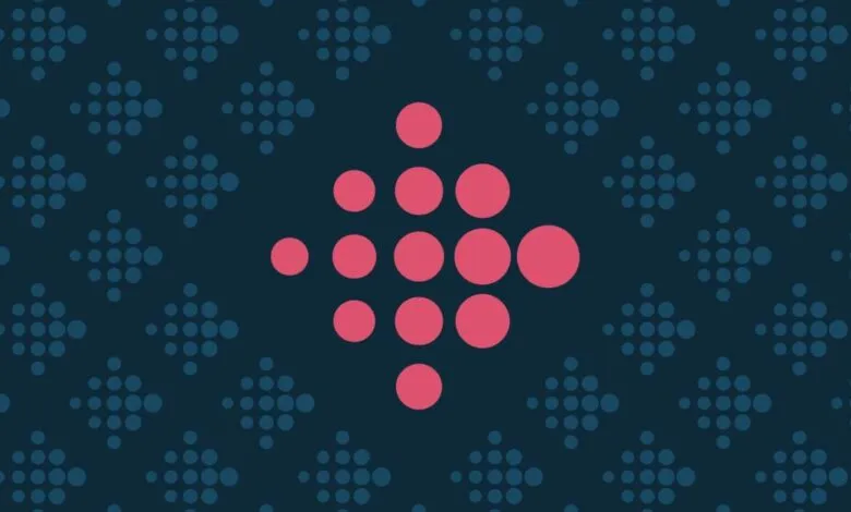 Fitbit logo made of pink circles on a dark blue patterned background.