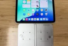 Foldable iPhone prototype with iPad on a wooden table.