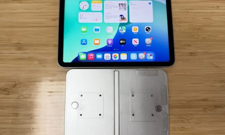 Foldable iPhone prototype with iPad on a wooden table.