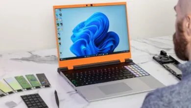 Framework Laptop 16 with customizable modules on a marble surface.