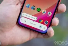 Hand holding a phone displaying the 'Ask Gemini' prompt and app icons.