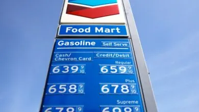 Chevron gas station sign showing high gasoline prices against a blue sky.