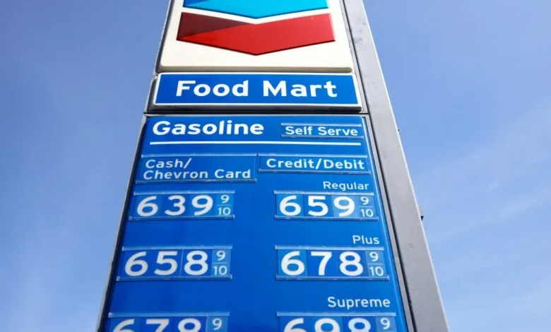 Chevron gas station sign showing high gasoline prices against a blue sky.