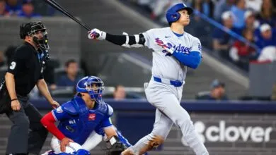 Dodgers batter swings at pitch during baseball game.